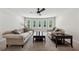 Bright living room features plush sofas, a ceiling fan, and multiple windows providing natural light at 107 Equest Dr, Canton, GA 30115