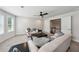 Upstairs living room includes neutral sofas, carpet, and ceiling fan at 107 Equest Dr, Canton, GA 30115