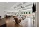 Open-concept living area with a tray ceiling, fireplace, and ample natural light at 107 Equest Dr, Canton, GA 30115