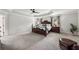 Large main bedroom with tray ceiling, carpeting, and dark wood furniture at 107 Equest Dr, Canton, GA 30115
