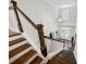 View of a staircase with wood treads and white risers leading to the front door and foyer at 107 Equest Dr, Canton, GA 30115