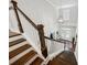 Grand foyer and staircase with hardwood steps, white risers and railings, and a modern chandelier at 107 Equest Dr, Canton, GA 30115