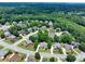 Beautiful aerial view of neighborhood, showcasing tree-lined streets and well-maintained homes at 1564 Stepstone Way, Lawrenceville, GA 30043