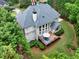 Aerial view of a backyard with a deck, patio furniture, and mature landscaping at 1564 Stepstone Way, Lawrenceville, GA 30043