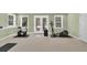 Finished basement area with exercise equipment, including a bike and elliptical machine at 1564 Stepstone Way, Lawrenceville, GA 30043
