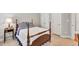 Comfortable bedroom with classic furnishings, carpet floors, and natural light from two windows at 1564 Stepstone Way, Lawrenceville, GA 30043