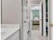 Open doorway view to the bedroom with green walls from the bathroom with white countertops at 1564 Stepstone Way, Lawrenceville, GA 30043