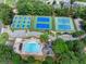 Aerial view of community pool and tennis courts surrounded by lush greenery at 1564 Stepstone Way, Lawrenceville, GA 30043
