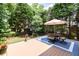 Relaxing deck with a table, chairs, and a lush green view at 1564 Stepstone Way, Lawrenceville, GA 30043