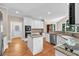 Bright kitchen with white cabinets, granite counters, stainless appliances, and hardwood floors at 1564 Stepstone Way, Lawrenceville, GA 30043