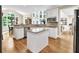 Open-concept kitchen with granite counters, stainless steel appliances, and hardwood floors at 1564 Stepstone Way, Lawrenceville, GA 30043