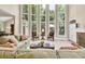 Bright living room features soaring windows, plush seating, and a fireplace for a cozy and elegant atmosphere at 1564 Stepstone Way, Lawrenceville, GA 30043