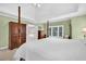 Expansive primary bedroom with tray ceiling, ensuite bathroom, and natural light from large windows at 1564 Stepstone Way, Lawrenceville, GA 30043
