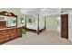 Large primary bedroom suite featuring a tray ceiling, and traditional wood furniture, with green walls at 1564 Stepstone Way, Lawrenceville, GA 30043