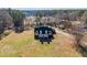 A high angle view of the charming brick home surrounded by mature trees at 1650 Old Loganville Rd, Loganville, GA 30052