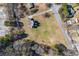 Expansive aerial view of a home on a large lot surrounded by mature trees and a paved road at 1650 Old Loganville Rd, Loganville, GA 30052