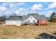 Backyard view of the home, the deck, and the three-car garage at 1650 Old Loganville Rd, Loganville, GA 30052