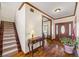 Inviting foyer features hardwood floors, wooden staircase and a decorative table at 1650 Old Loganville Rd, Loganville, GA 30052