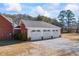 A three-car garage with white doors and a gray roof at 1650 Old Loganville Rd, Loganville, GA 30052