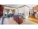 Open kitchen featuring an island with bar seating, tile floors, and views into the great room at 1650 Old Loganville Rd, Loganville, GA 30052