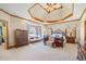 Expansive main bedroom showcasing a tray ceiling, sitting area, and ample natural light at 1650 Old Loganville Rd, Loganville, GA 30052