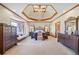 Spacious main bedroom with a unique tray ceiling and sitting area for relaxation at 1650 Old Loganville Rd, Loganville, GA 30052
