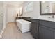 Stylish bathroom featuring a soaking tub, marble countertop, and a glass shower at 258 Dawson Dr, Woodstock, GA 30188