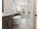 Modern bathroom boasting a soaking tub, double vanity, and glass enclosed shower at 258 Dawson Dr, Woodstock, GA 30188