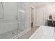 Clean bathroom featuring a tile shower with glass door and white soaking tub at 258 Dawson Dr, Woodstock, GA 30188