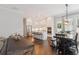Open dining area features dark wood floors, a farm table and views of the kitchen at 258 Dawson Dr, Woodstock, GA 30188