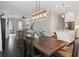 Open dining area, dark wood floors, farm table, view into the kitchen and living room at 258 Dawson Dr, Woodstock, GA 30188