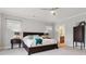Cozy main bedroom with a ceiling fan, dresser, and adjoining bathroom at 258 Dawson Dr, Woodstock, GA 30188