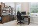Home office featuring a desk, shelves, and a view of outdoors at 258 Dawson Dr, Woodstock, GA 30188