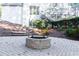 Backyard featuring a brick fire pit and manicured landscaping at 3258 Bransley Way, Duluth, GA 30097