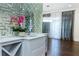 Stylish wet bar featuring a unique mirrored backsplash and marble countertop at 3258 Bransley Way, Duluth, GA 30097