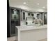 Basement bar featuring a modern island with elegant gray cabinetry and shelves at 3258 Bransley Way, Duluth, GA 30097