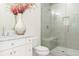 Bathroom features a glass shower, white vanity, and decorative vase with flowers at 3258 Bransley Way, Duluth, GA 30097