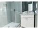 Bathroom showcasing a glass enclosed shower, white vanity, and a decorative mirror at 3258 Bransley Way, Duluth, GA 30097