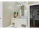 Bathroom vanity with white cabinets, marble countertop, and view of a staircase at 3258 Bransley Way, Duluth, GA 30097
