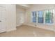 Bright bedroom featuring herringbone floors, three large windows, and a door to the backyard at 3258 Bransley Way, Duluth, GA 30097
