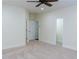 An airy bedroom with neutral carpet, ceiling fan and multiple entry ways at 3258 Bransley Way, Duluth, GA 30097