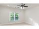 Bright bedroom features neutral carpet, ceiling fan, and natural light from the windows at 3258 Bransley Way, Duluth, GA 30097