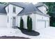 Beautiful, two-story home showcasing manicured landscaping, side door, and an attached three-car garage at 3258 Bransley Way, Duluth, GA 30097