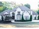 Stunning two-story home with manicured lawn, a circular driveway, and a stately facade at 3258 Bransley Way, Duluth, GA 30097