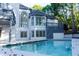 An exterior angle of a home featuring a well-maintained pool and a two-story house with large windows at 3258 Bransley Way, Duluth, GA 30097