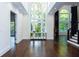 Open foyer with soaring ceilings, large windows, gleaming hardwood floors, and a decorative table at 3258 Bransley Way, Duluth, GA 30097