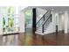 Beautiful foyer with high ceilings, huge windows, elegant staircase, and gleaming hardwood floors at 3258 Bransley Way, Duluth, GA 30097