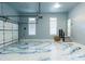 Bright garage showcases epoxy floors, windows, and access to the home at 3258 Bransley Way, Duluth, GA 30097