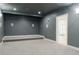 Cozy home theater featuring a raised platform, gray walls, and carpeted flooring at 3258 Bransley Way, Duluth, GA 30097