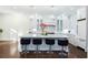 Gourmet kitchen featuring a large island with seating, modern lighting, and custom cabinets at 3258 Bransley Way, Duluth, GA 30097